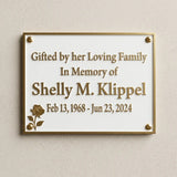 Memorial plaque for Shelly M. Klipple on a beige wall