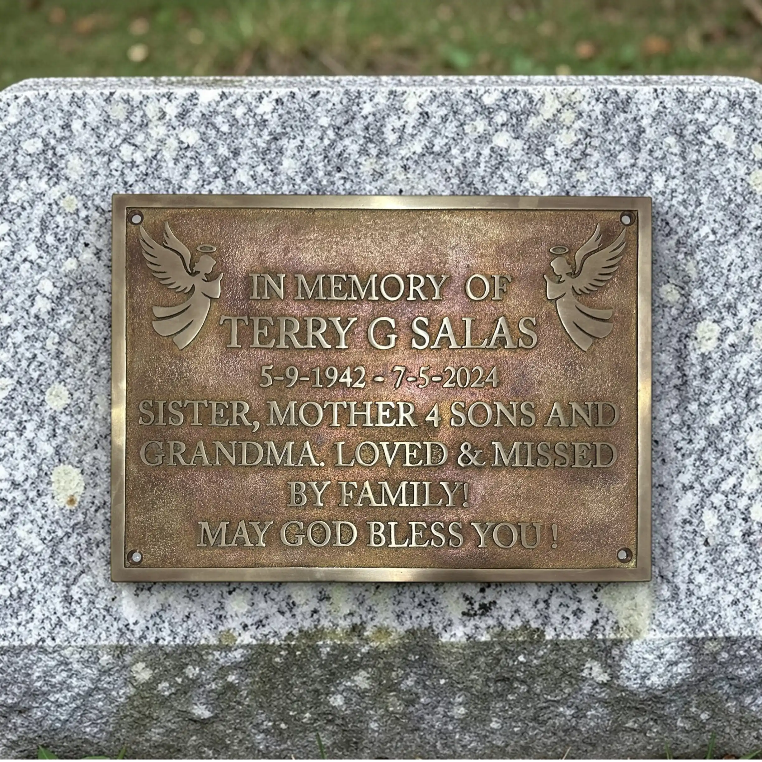 Bronze plaque on a stone wall with engraved text in memory of Terry G Salas.