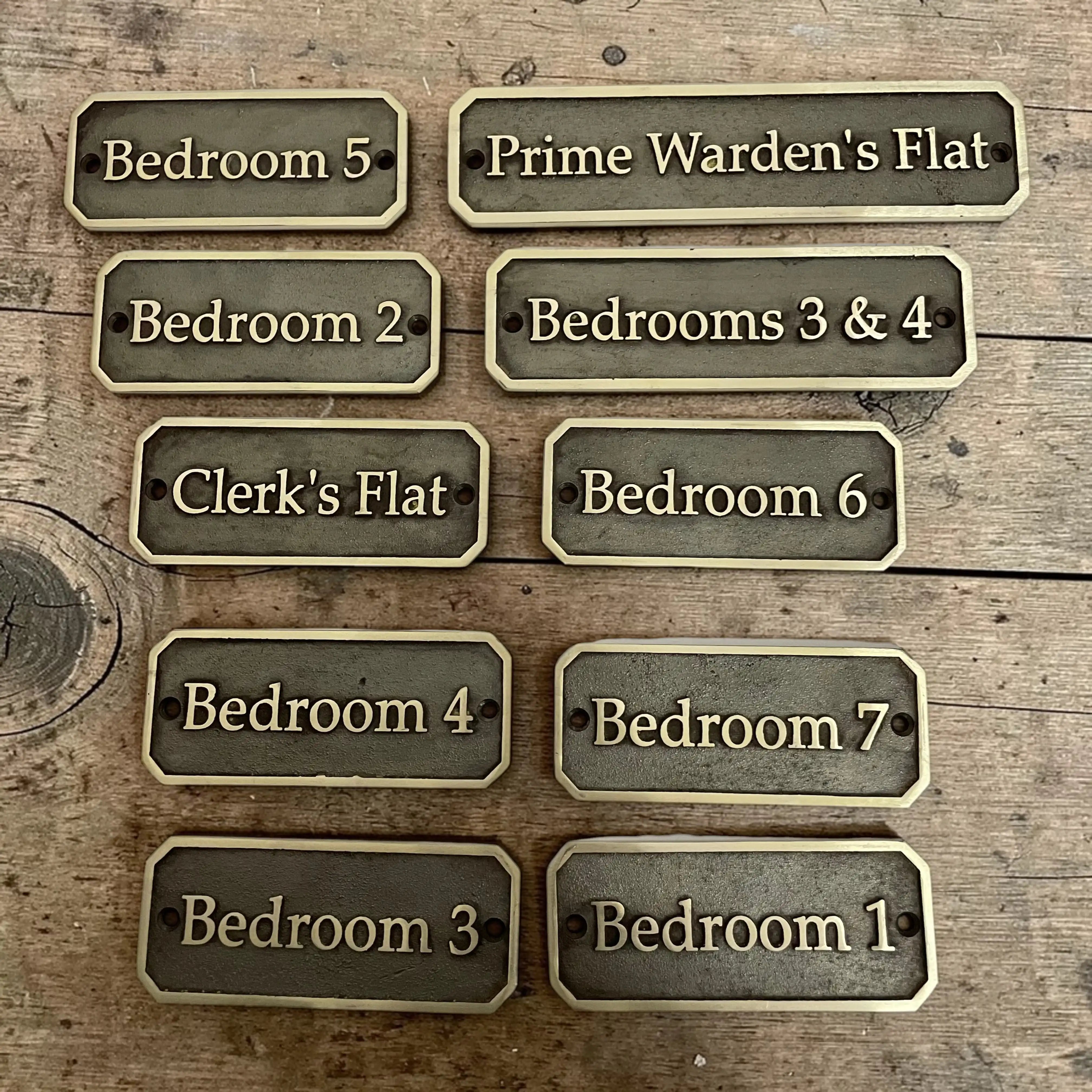 Set of metal bedroom signs on a wooden background