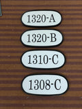 Four oval address plaque with text on a striped brown background