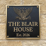Bronze Plaque with eagle design and 'The Blair House Est. 2026' text on a stone wall.