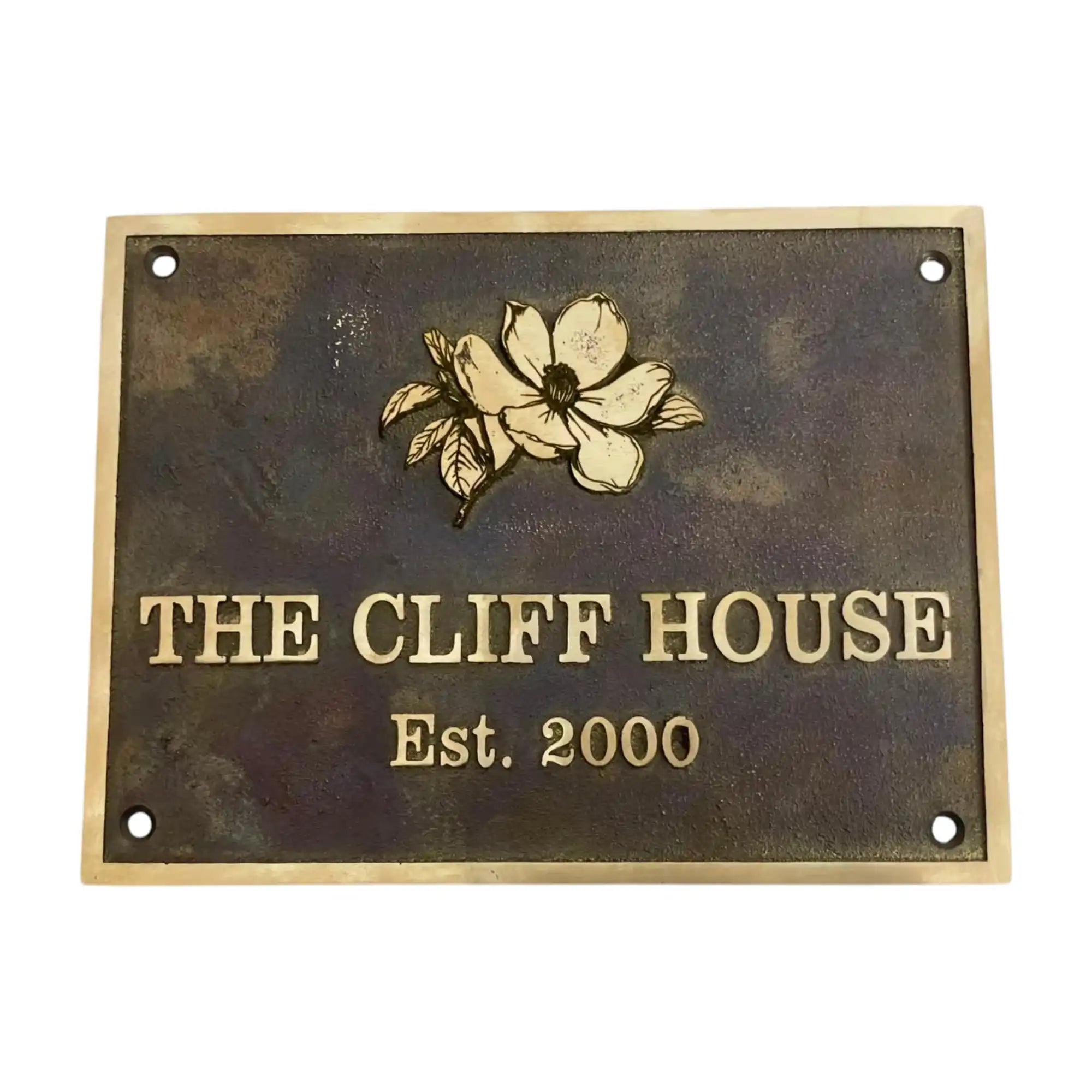 Bronze metal sign with floral design and text 'The Cliff House Est. 2000' on a white background