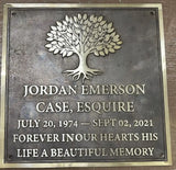 Memorial plaque with a tree design and engraved text on a metallic background