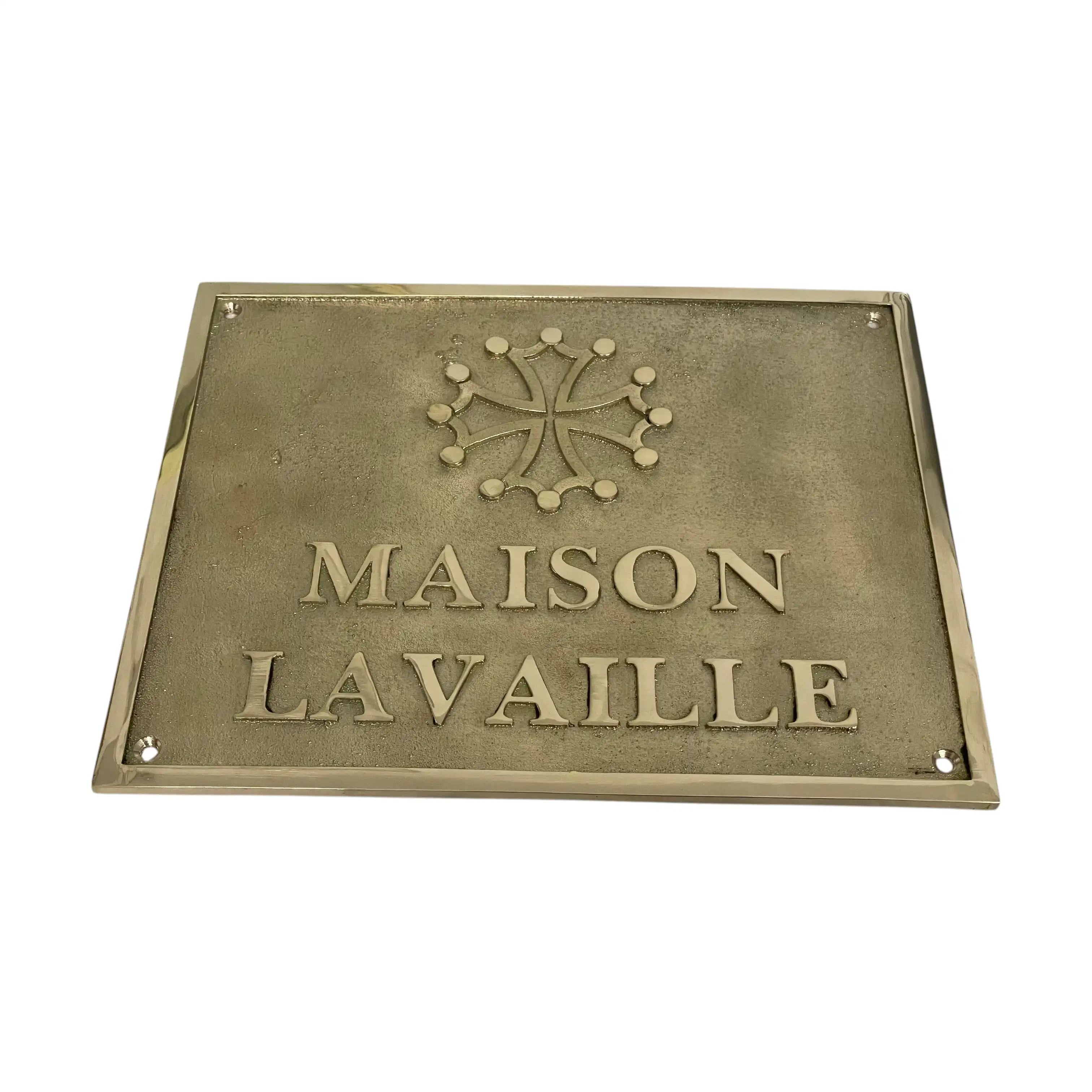 Brass plaque with 'MAISON LAVAILLE' text and logo on a white background