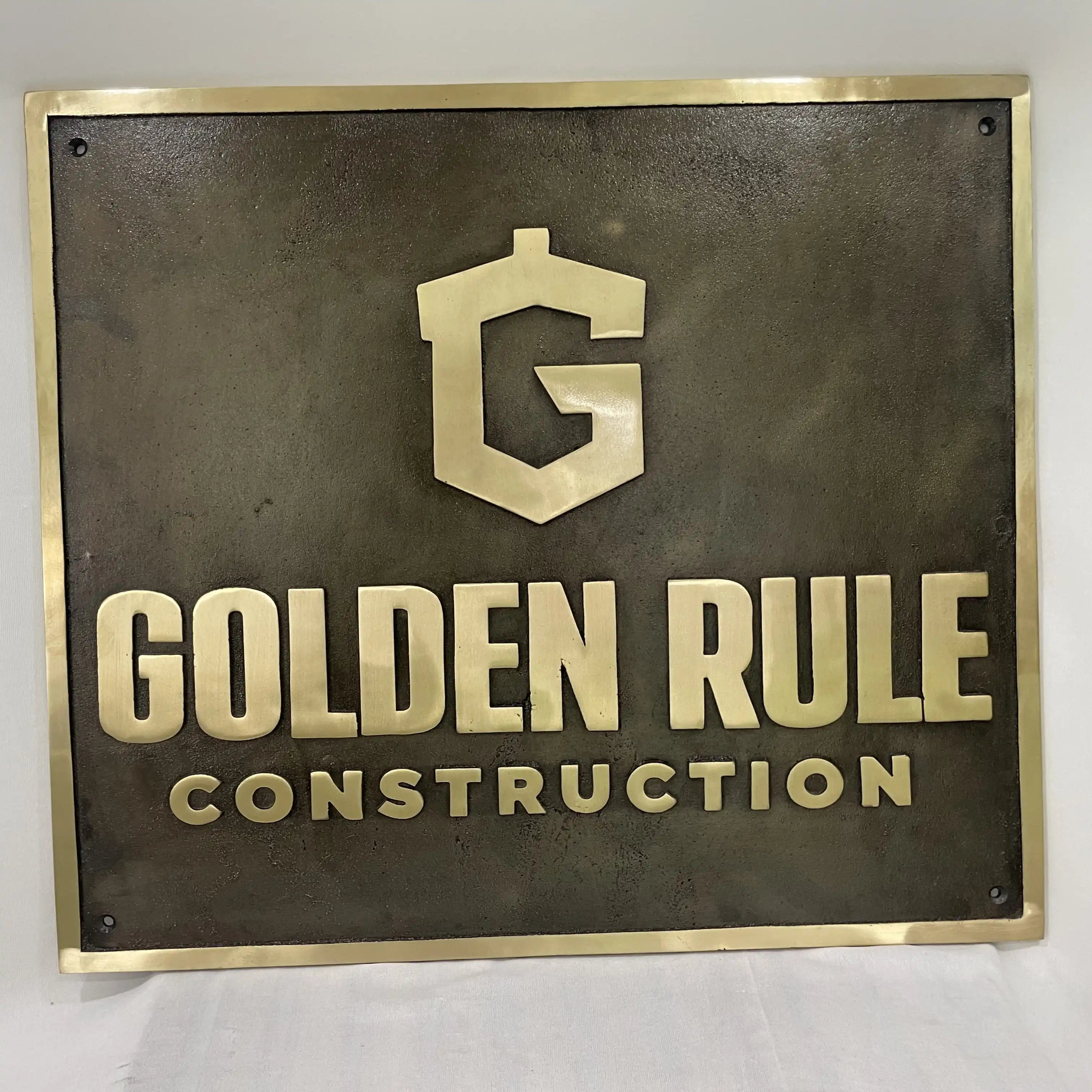 Bronze Metal sign with 'Golden Rule Construction' logo and text on a white background