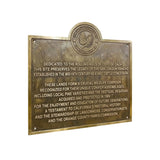 Bronze plaque with engraved text on a white background