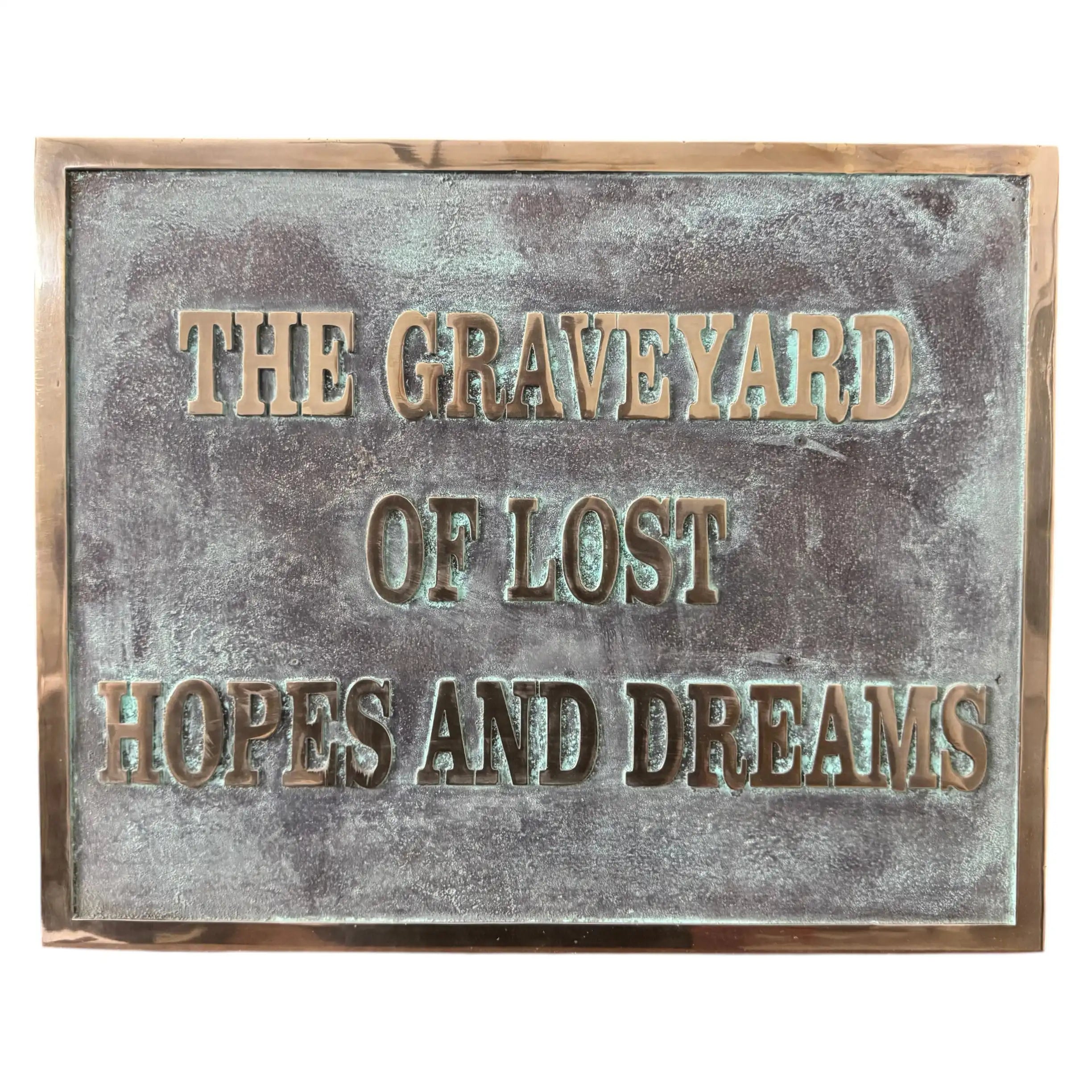 Bronze plaques with text 'The Graveyard of Lost Hopes and Dreams' on a textured surface.
