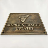 Bronze plaque with a dog illustration and 'Morgen Franch Estates' text on a white background