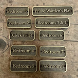 Set of metal bedroom signs on a wooden background