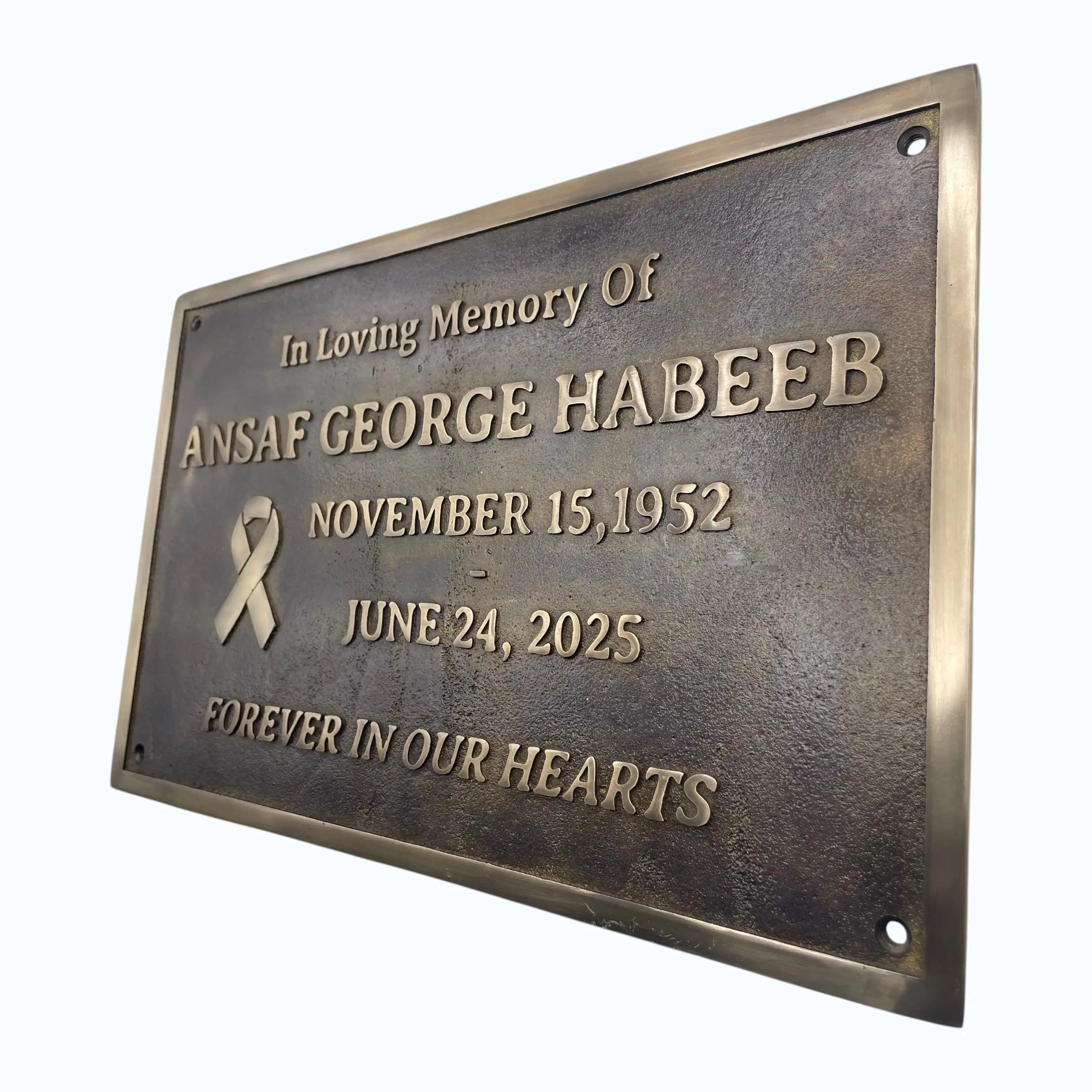 Memorial plaque for Ansaaf George Habeeb with a bronze finish on a white background