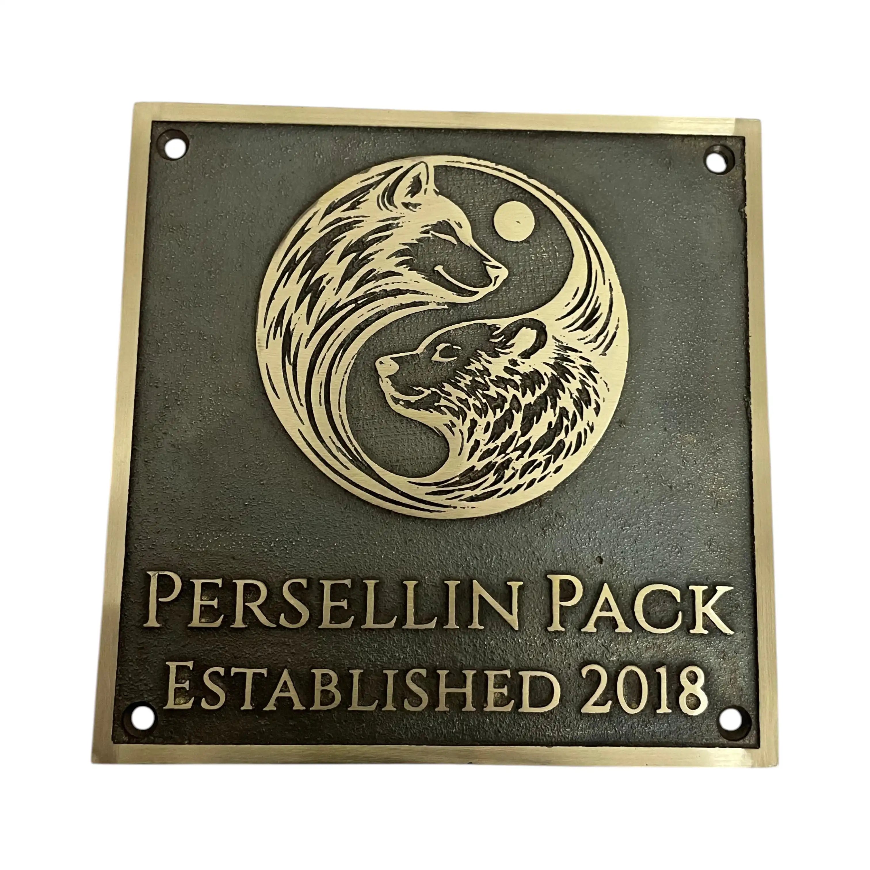 Bronze plaque with wolf design and 'Persellin Pack Established 2018' text on a white background