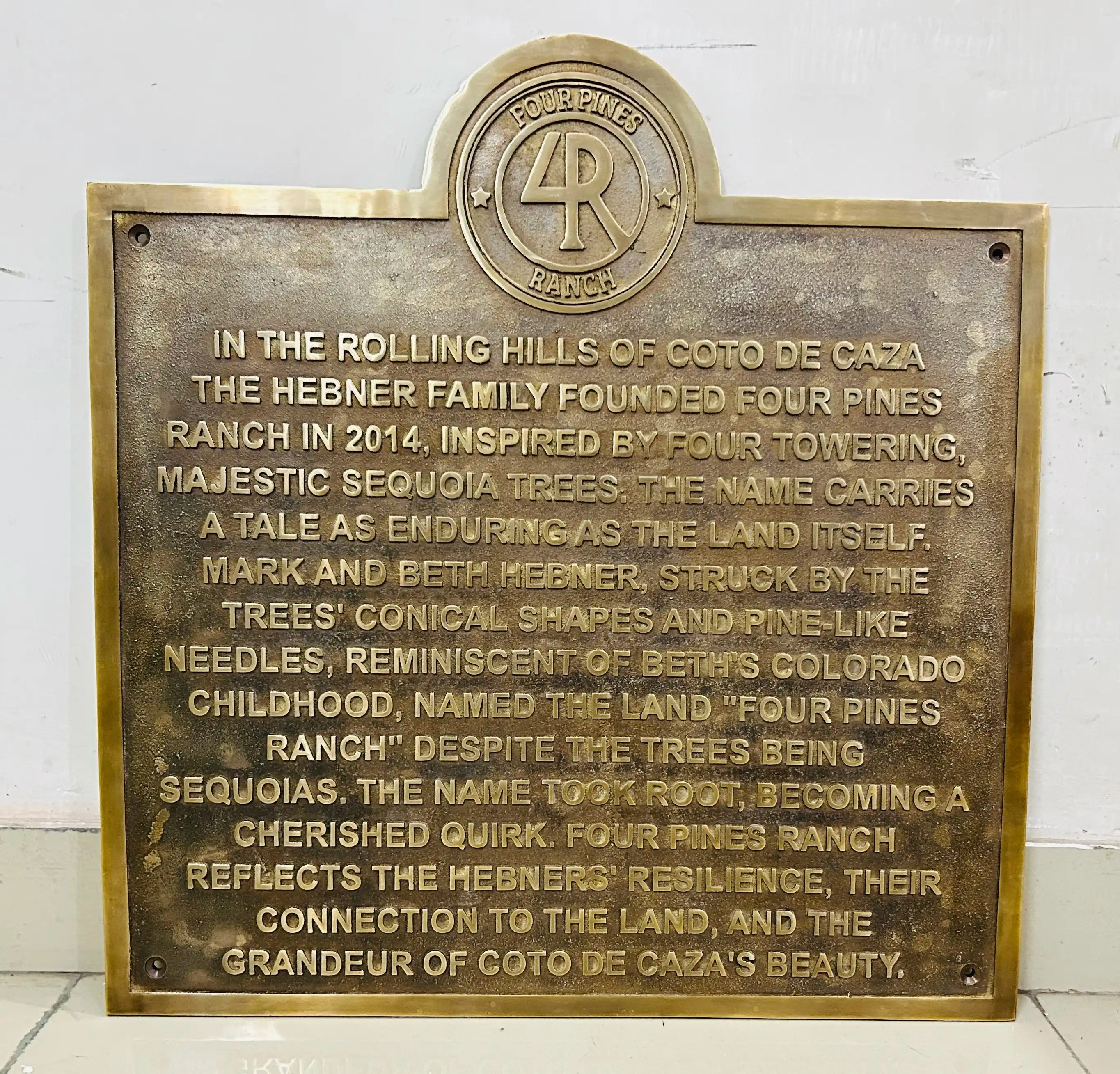 Bronze plaque with engraved text on a white background