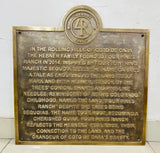 Bronze plaque with engraved text on a white background