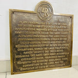 Bronze plaque with engraved text and Four Pines Ranch logo on a white background