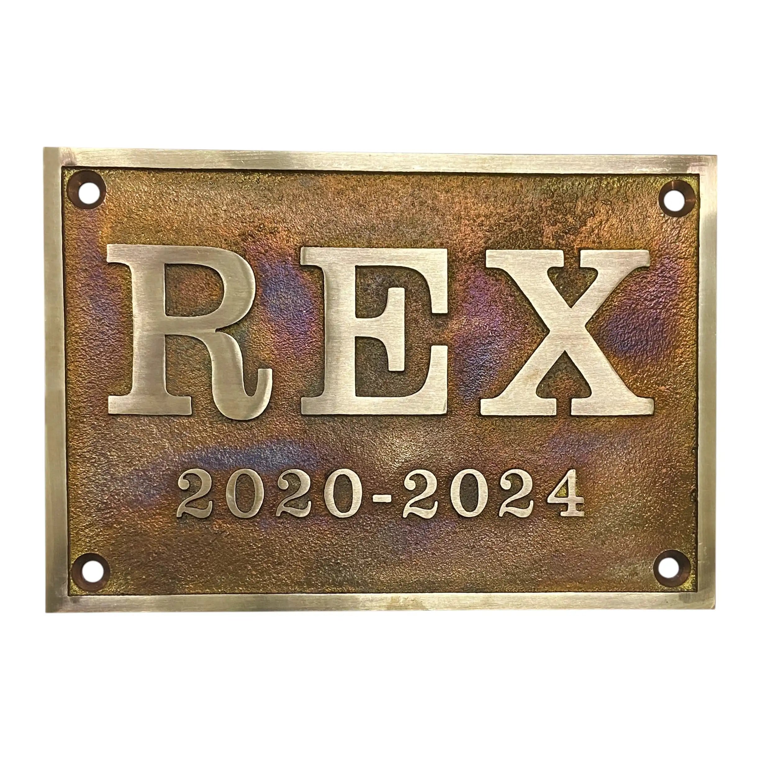 Aged bronze plaque with 'REX' and dates 2020-2024 on a white background