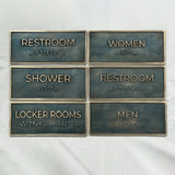 Custom metal nameplate sign antique finish - Set of restroom signs with Braille text on a white background