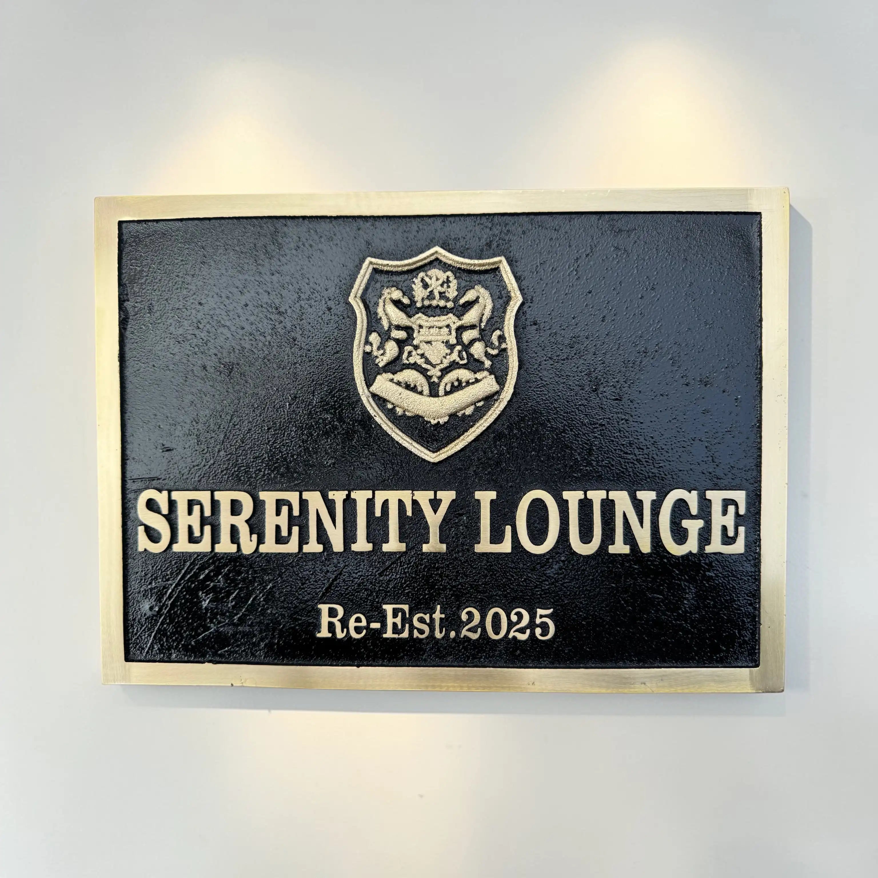 Serenity Lounge sign with crest on a wall
