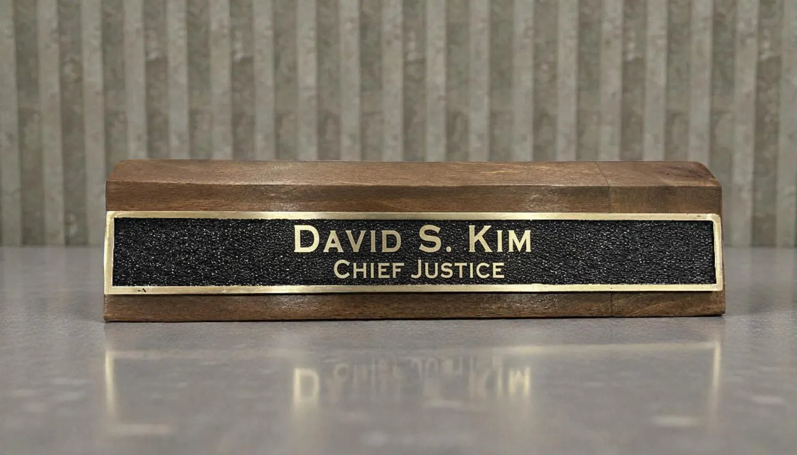Custom brass office name sign black background