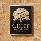 Bronze plaque address sign with tree design and 'CHIEF EST. 2026' text on a stone wall.