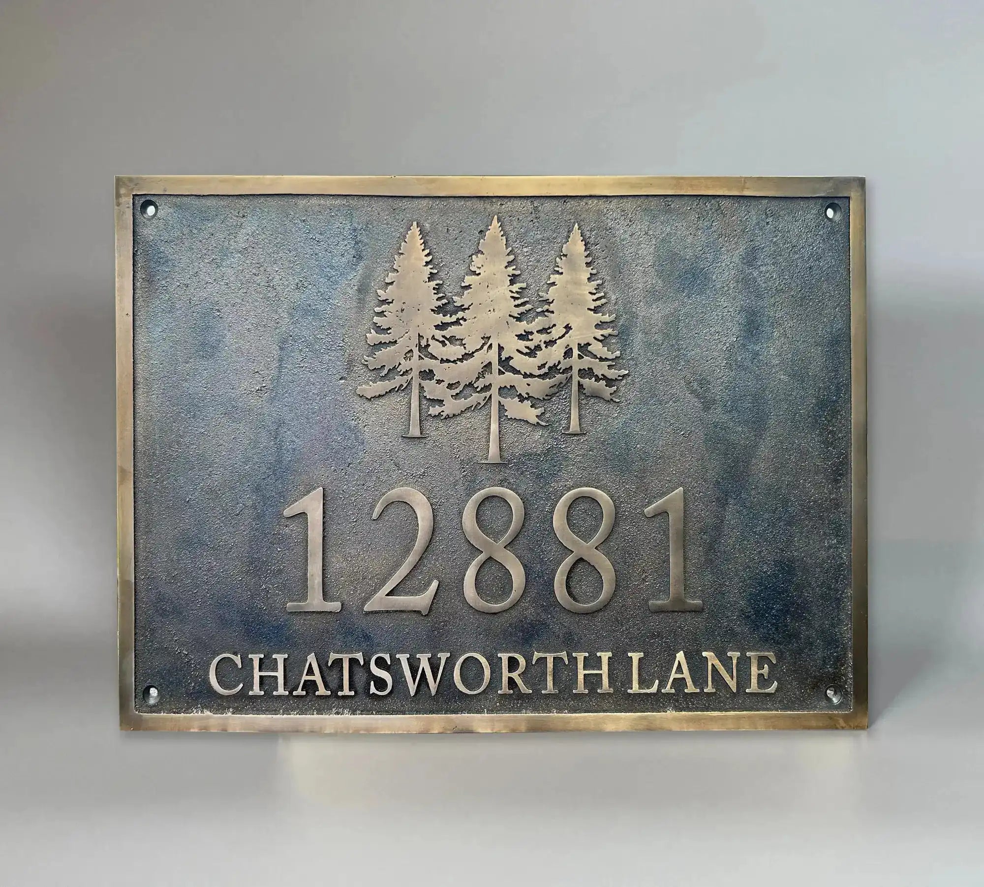 Bronze house number plaque with dark oxidized background