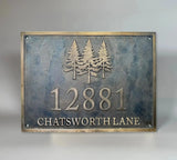 Bronze house number plaque with dark oxidized background