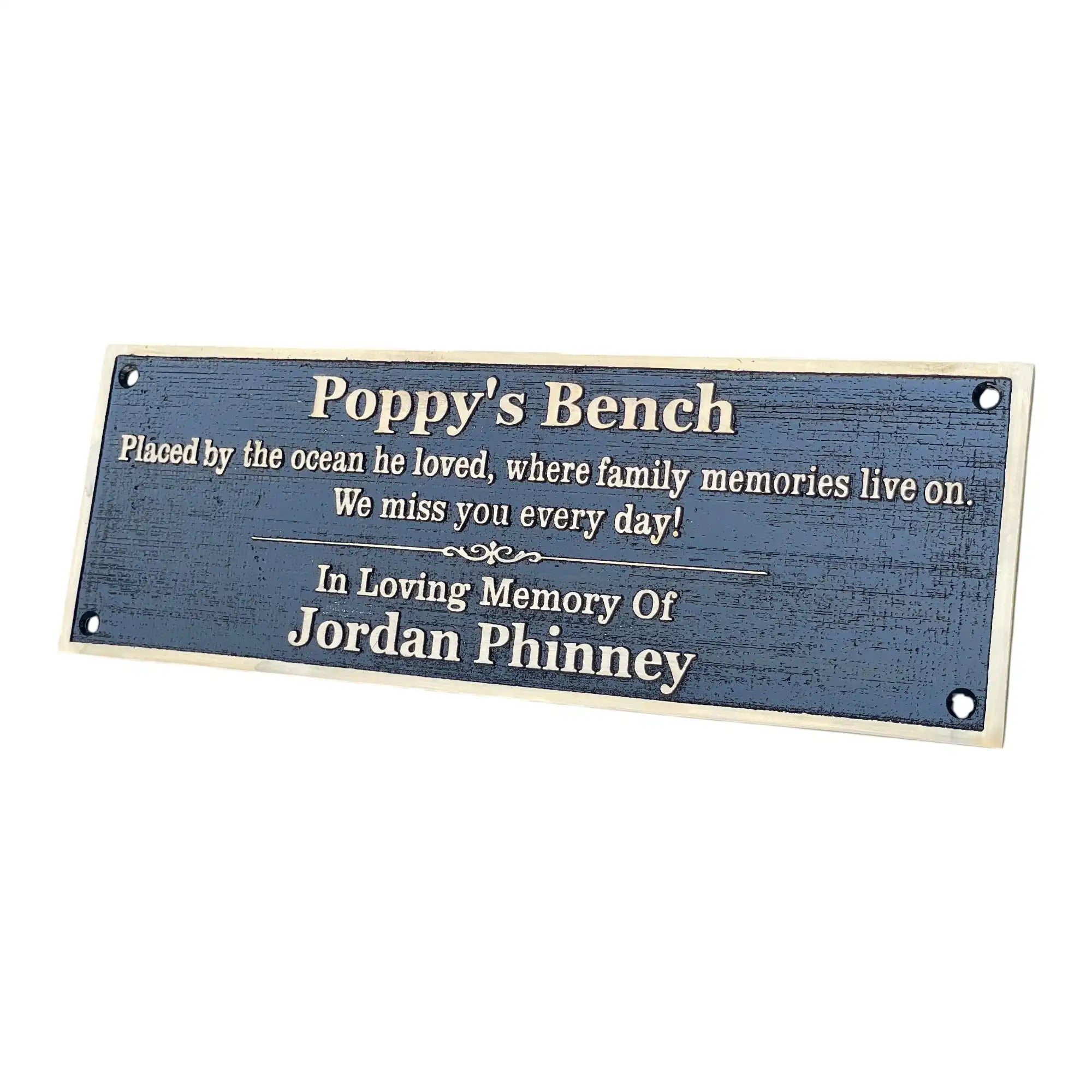 Memorial plaque for 'Poppy's Bench' with text about family memories and a name.