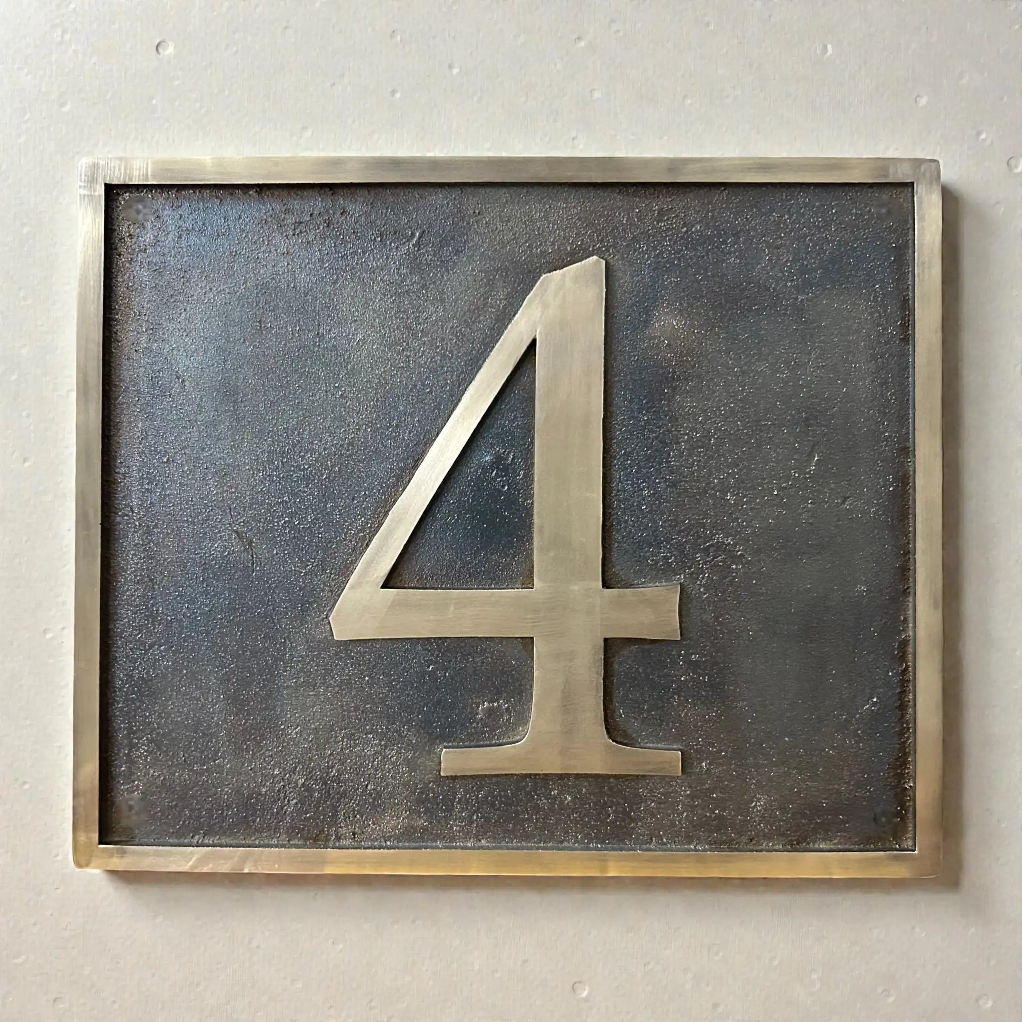 Custom bronze address plaque with antique finish and raised numerals
