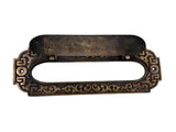 Decorative bronze mail slot with intricate designs on a white background