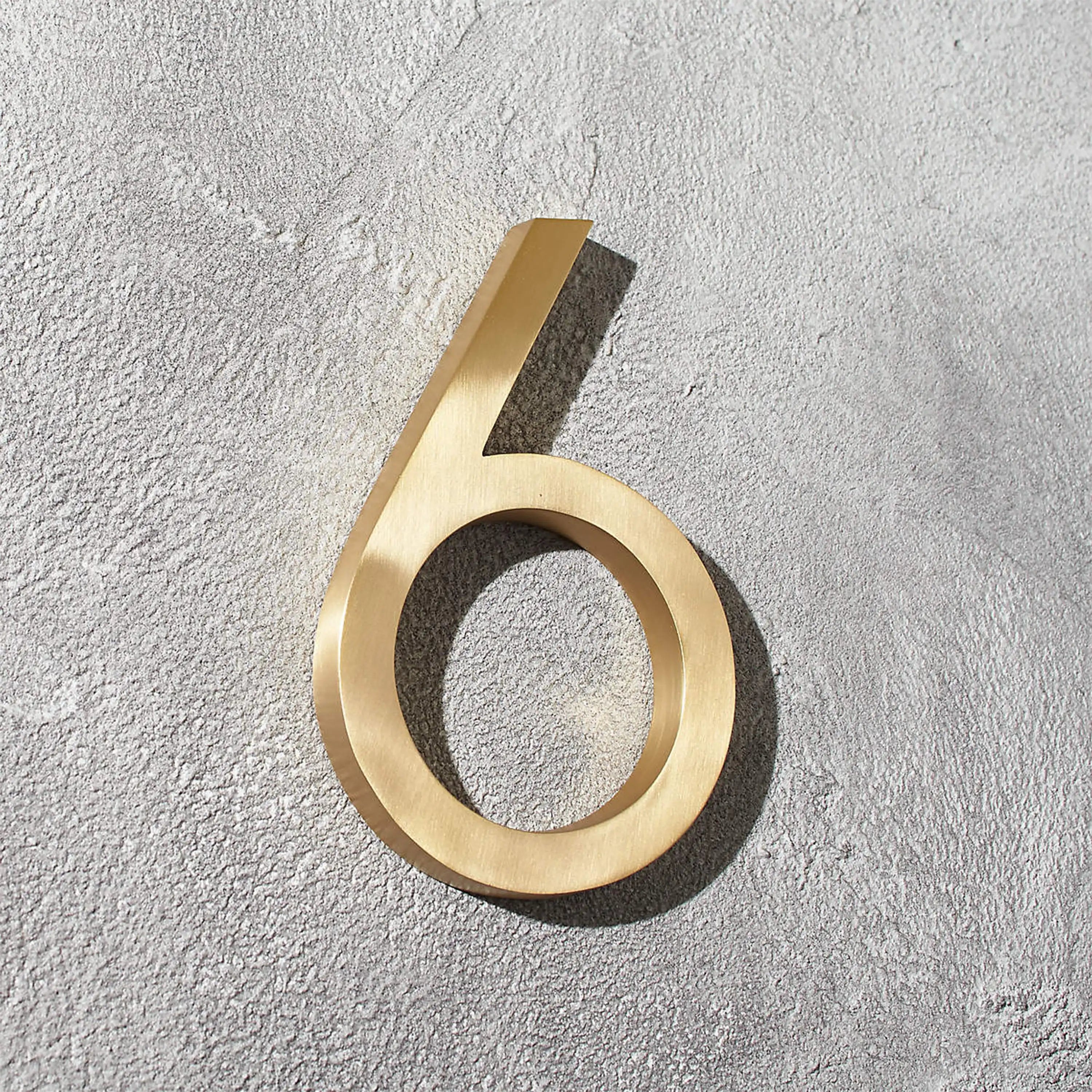 Solid brass floating room and door numbers with hidden studs for offices, hotels, apartments, and interior spaces.